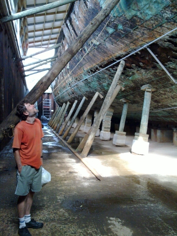 Guy looking at old timbers